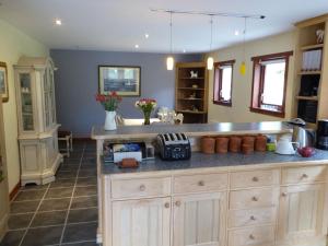 a kitchen with a counter with a sink and a counter sidx sidx sidx at Craigruie Farmhouse in Balquhidder