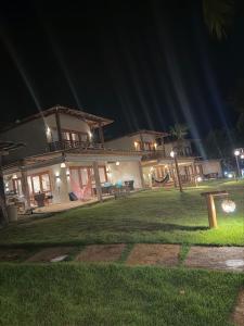 a house at night with a bench in the yard at casa LuMar in Atins