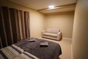 a small room with a bed and a chair at Cherry Rooms in Tromsø +19 photos