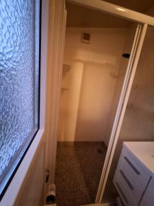 a glass door to a closet in a bathroom at Chalet in menaam in Dronrijp +9 photos