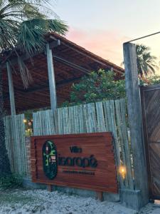 a sign for a wine bar on the beach at casa LuMar in Atins