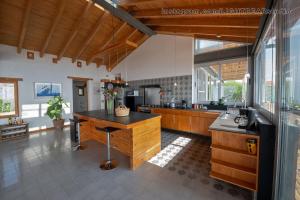 a large kitchen with wooden cabinets and a counter at Utopia Casas Boutique in Oaxaca City