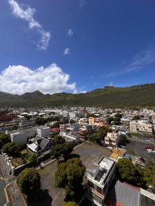 an aerial view of a city with mountains in the background at Le Saint Georges Hotel in Port Louis