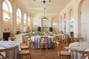 a set up for a wedding in a large room with tables and chairs at Kings Head Hotel in Cirencester