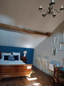 a bedroom with a bed and a blue wall at Sharecroppers Cottage with Swimming Pool in Pagéas +87 photos