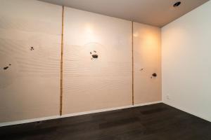 a large room with a large wall ofillanceillanceillanceillanceillance at 三十三Kumo in Kyoto