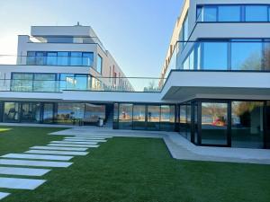 a large building with a lawn in front of it at Przystań Nadole in Nadole