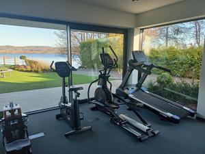 a gym with two tread machines and a large window at Przystań Nadole in Nadole