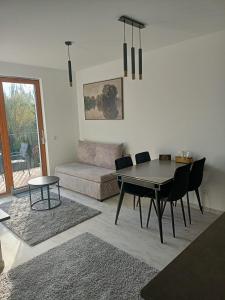 a living room with a table and a couch at Przystań Nadole in Nadole