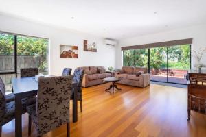 a living room with a couch and a table at Welcome home Burwood in Burwood