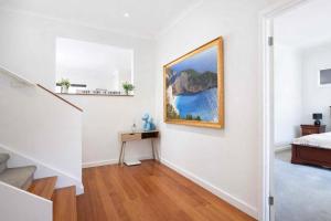 a white room with a painting on the wall at Welcome home Burwood in Burwood +21 photos