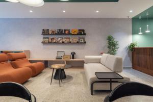 a lobby with a couch and chairs and a table at 224 Boutique Hostel in Sliema +35 photos