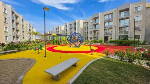 a playground with a bench in the middle of a park at Capriella, Serena Del Mar in Cartagena de Indias