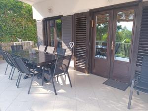 a black table and chairs on a patio at SUNSHINE CRIKVENICA in Crikvenica