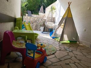 a childs play area with toys and a tent at SUNSHINE CRIKVENICA in Crikvenica