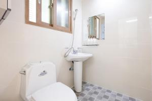 a bathroom with a toilet and a sink at Suncheon Bay Ecology Pension in Suncheon +27 photos