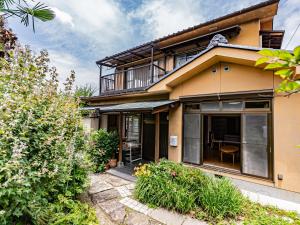 a house with large windows and a balcony at The M HONMACHI in Nakatsugawa