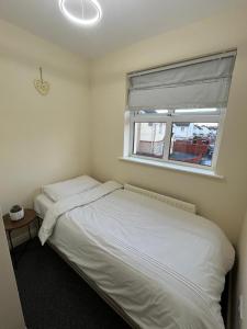 a bedroom with two beds and a window at Carriegart in Lurgan