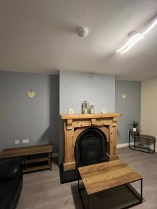 a living room with a fireplace and a table at Carriegart in Lurgan +1 photo