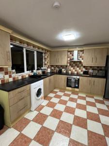 a large kitchen with a checkered floor at Carriegart in Lurgan