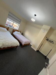 a bedroom with two beds and a window at Carriegart in Lurgan
