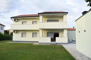 a house with a lawn in front of it at Villa Majra in Valbandon