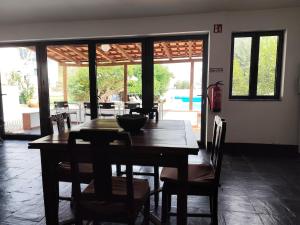 a dining room with a wooden table and chairs at Costas Guests in Sardoal