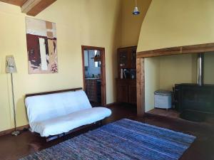 a living room with a bed and a tv at Costas Guests in Sardoal