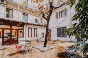 a courtyard with tables and chairs and a tree at Hotel Astoria in Turin