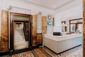 an office with a reception desk in a building at Hotel Astoria in Turin