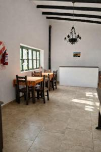 a dining room with a table and chairs and a chandelier at Inti Raymi in Maimará
