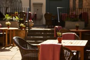 a table and chairs in a restaurant with stairs at Kings Head Hotel in Cirencester