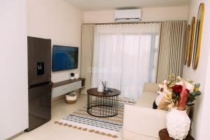 a living room with a couch and a television at Suite 303 in Gaborone