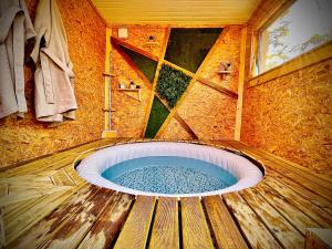 a bathroom with a jacuzzi tub in a room at La Verdine Lodge & Spa in Romorantin