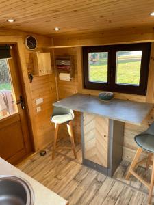 a kitchen with a counter in a tiny house at La Verdine Lodge & Spa in Romorantin