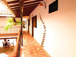 a hallway of a house with a table and chairs at Hotel Villa Del Socorro in Socorro