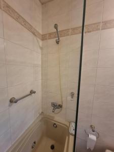 a bathroom with a tub and a shower stall at Emmac Zen in Ciudad Lujan de Cuyo +18 photos