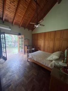 a bedroom with a bed and a sliding glass door at Emmac Zen in Ciudad Lujan de Cuyo