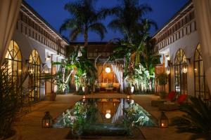 a courtyard of a building with a fountain in the middle at Daba Village in Marrakesh