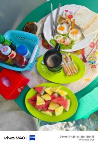 a table topped with plates of food and fruit at Fa eap Bungalow in Ko Lanta Yai +46 photos