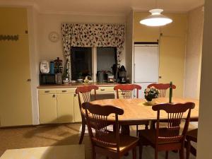 a kitchen with a wooden table and chairs and a kitchen with a table at Large family housing in Mariannelund