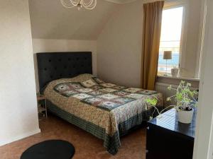 a bedroom with a bed and a window at Large family housing in Mariannelund