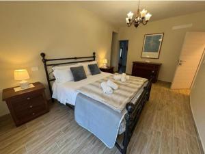 a bedroom with a large bed with two pillows at Bottega del Sogno in Alice Bel Colle