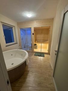 a bathroom with a large bath tub and a window at Bottega del Sogno in Alice Bel Colle
