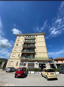 a large building with cars parked in a parking lot at Officina dei ricordi in Casagiove