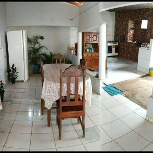 a kitchen with a table and chairs in a room at casa Beija Flor in Riachão