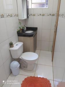 a small bathroom with a toilet and a sink at casa Beija Flor in Riachão +6 photos
