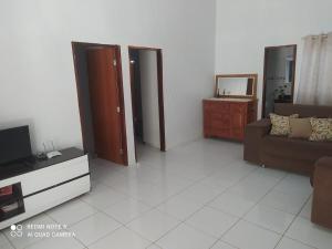 a living room with a couch and a tv at casa Beija Flor in Riachão
