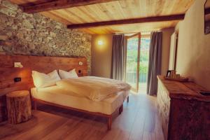 a bedroom with a bed and a large window at Moncervin in Saint Vincent