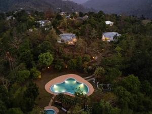 an aerial view of a swimming pool in a resort at VANVASA RESORTs in Kānda